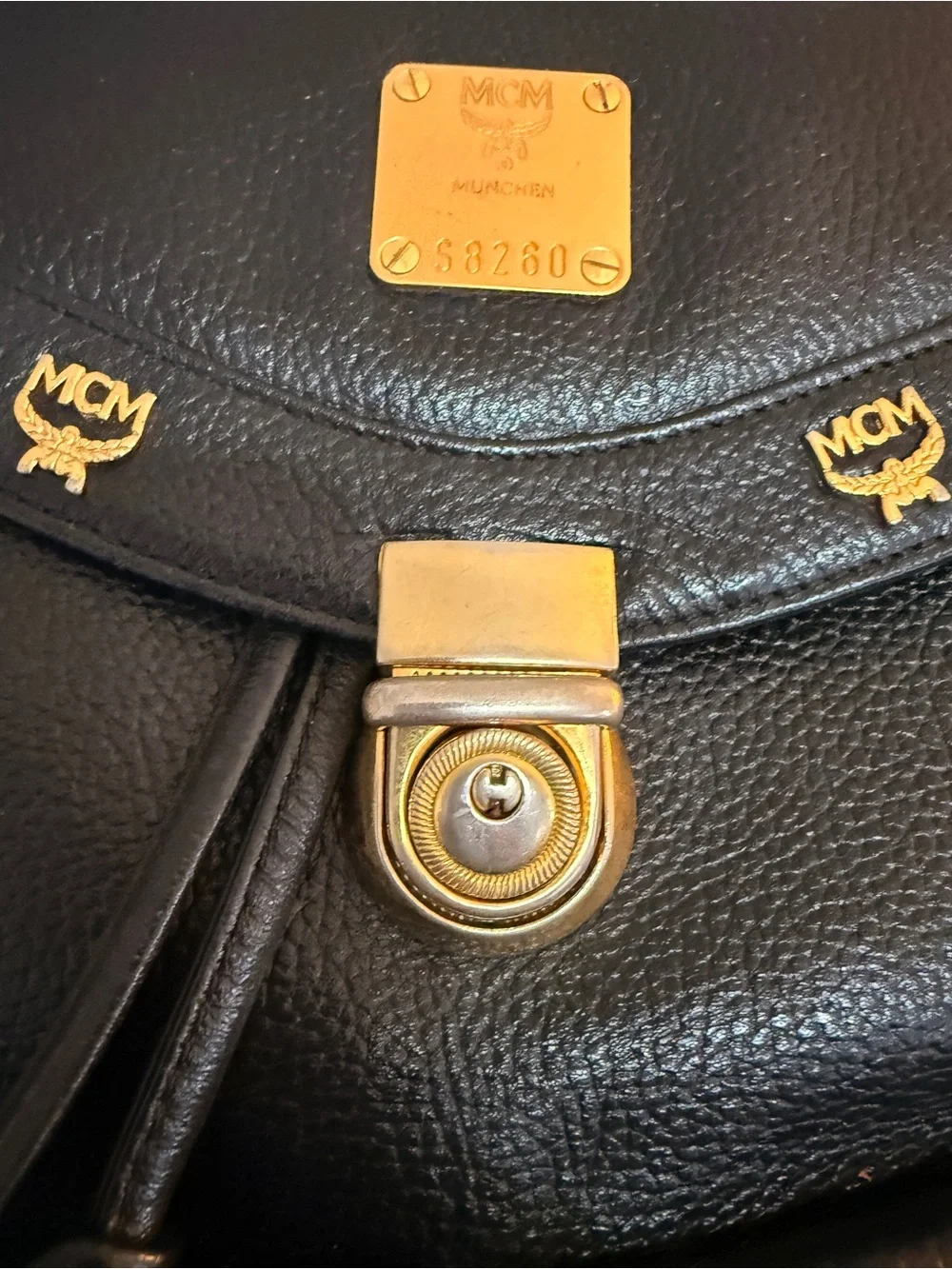 MCM Black Leather Backpack with Gold Accents and Front Pockets